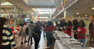 York College students at walking in the atrium as SGA members prepare to share food for their annual Thanksgiving dinner.